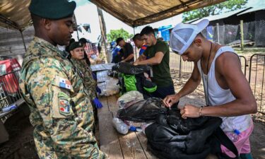 People arrive at the Reception Center for Migrant Care in Lajas Blancas