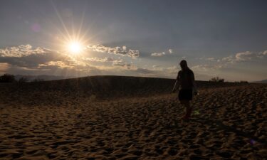 A tourist hikes in the Mesquite Flat Sand Dunes in Death Valley National Park