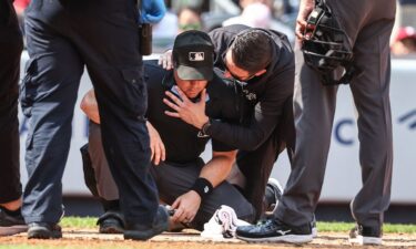 A medical staff member from the New York Yankees checks umpire Nick Mahrley after a broken bat hit him in the fifth inning of a game at Yankee Stadium on August 25.