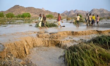 Damaged trucks buried in the mud after the collapse of the Arba'at Dam in Sudan following heavy rains and torrential floods on August 25