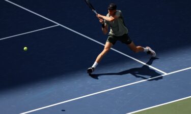 Jannik Sinner returns against Mackenzie McDonald in the first round of the US Open.