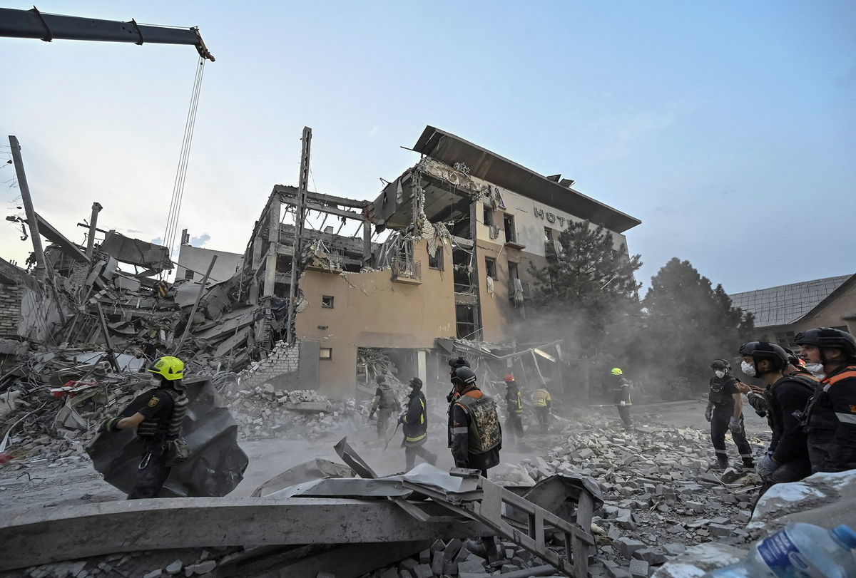 <i>Reuters via CNN Newsource</i><br/>Rescuers work at a site of a Russian missile strike