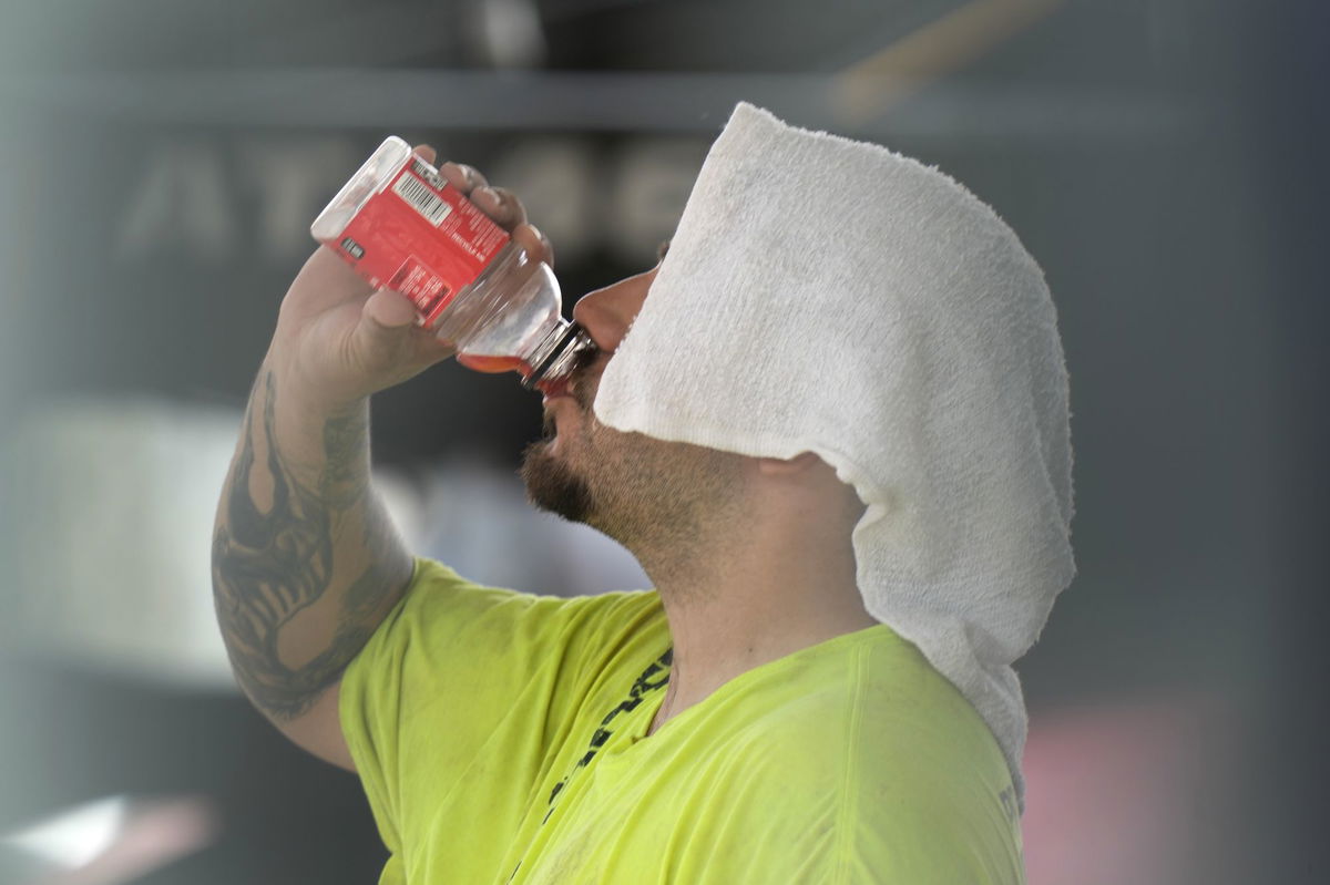 <i>Charles Rex Arbogast/AP via CNN Newsource</i><br/>A construction worker hydrates at the Shedd Aquarium Tuesday