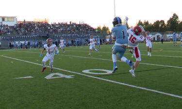 A Skyline Grizzlies football player makes a leaping catch.