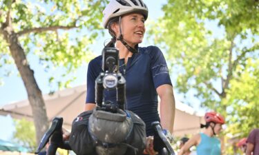 Lael Wilcox prepares to resume riding after taking a break in the Santa Fe Plaza on September 4.