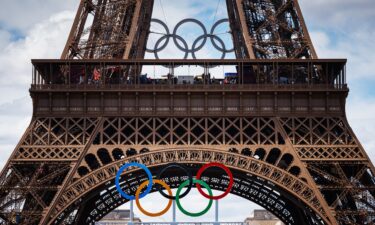 Medallists parade in front of the Eiffel Tower during the Games.