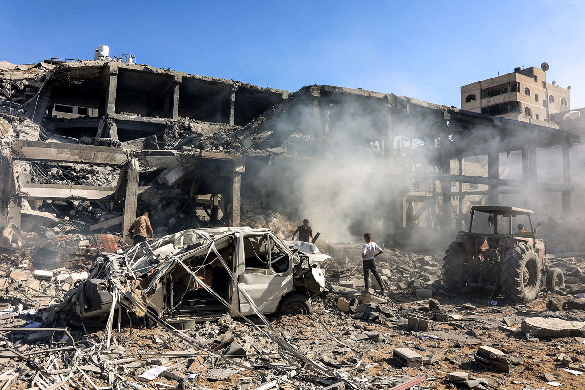 <i>Omar Al-Qatta/AFP/Getty Images via CNN Newsource</i><br/>Men walk through debris in a building that was hit by Israeli bombardment in the Sheikh Radwan neighbourhood in the north of Gaza City on September 3.