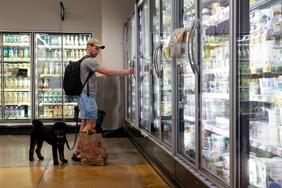 <i>Liao Pan/China News Service/Getty Images/FILE via CNN Newsource</i><br/>A customer shops for dairy products at a supermarket in Manhattan on July 11 in New York City.