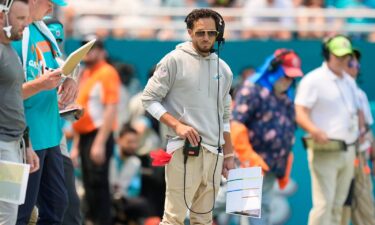 Miami Dolphins head coach Mike McDaniel embraces Tua Tagovailoa as he leaves the field after suffering a concussion against the Buffalo Bills.