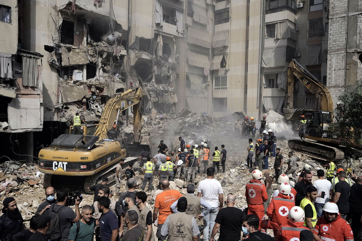 <i>Bilal Hussein/AP via CNN Newsource</i><br/>Emergency workers use excavators to clear the rubble at the site of the Israeli strike in Beirut's southern suburbs on September 20.