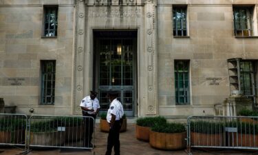 Police officers stand in front of the Department of Justice in Washington