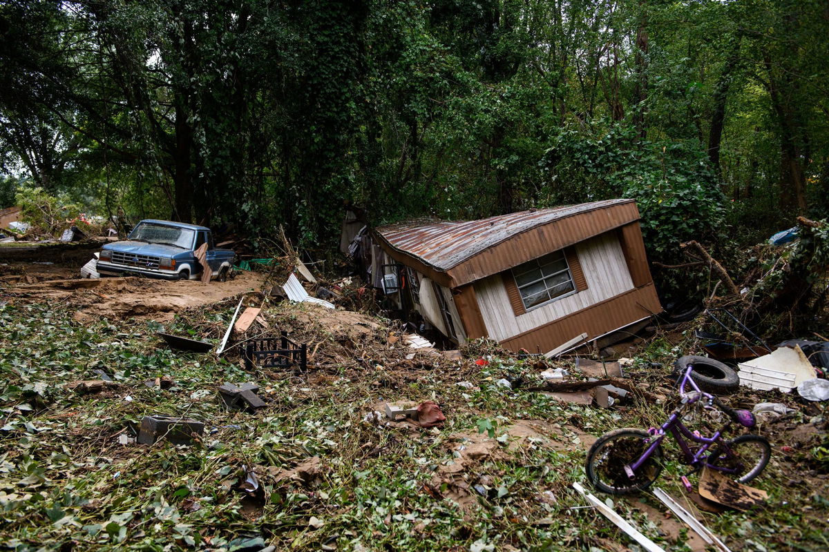 <i>Melissa Sue Gerrits/Getty Images via CNN Newsource</i><br/>Debris and a mobile home are piled up along a tree line in the aftermath of Hurricane Helene on September 29 in Old Fort