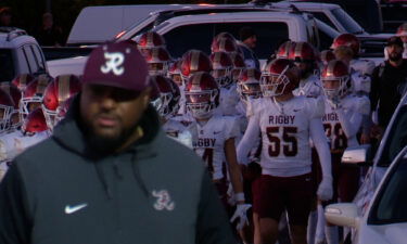 The Rigby Trojans enter Westmark Stadium through its parking lot.