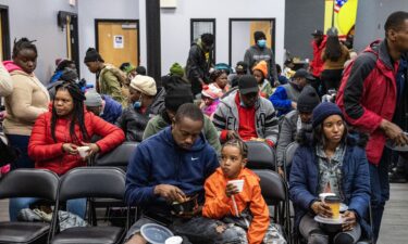 Migrants eat a meal at the La Colaborativa day shelter in Chelsea