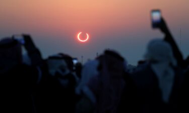 A global map shows the path of the annular solar eclipse on October 2.