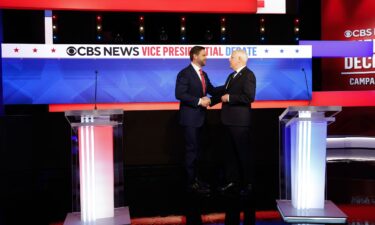 Ohio Sen. JD Vance and Minnesota Gov. Tim Walz greet each other ahead of a debate at the CBS Broadcast Center on October 1 in New York City.