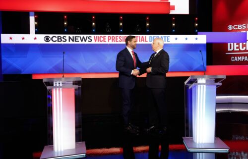 Ohio Sen. JD Vance and Minnesota Gov. Tim Walz greet each other ahead of a debate at the CBS Broadcast Center on October 1 in New York City.