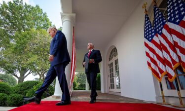 US President Donald Trump is followed by Vice President Mike Pence in the Rose Garden of the White House on September 28