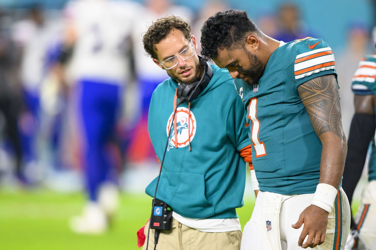 <i>Doug Murray/AP via CNN Newsource</i><br/>Miami Dolphins quarterback Tua Tagovailoa (right) walks off the field with head coach Mike McDaniel during the game against the Buffalo Bills.