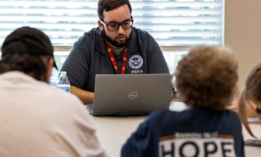 A FEMA worker attends claims by local residents after being affected by floods following the passing of Hurricane Helene