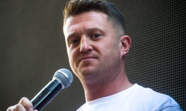 British far-right activist Tommy Robinson (real name Stephen Yaxley-Lennon) is shown speaking to supporters in London in 2021. Robinson has been jailed for 18 months after he admitted to being in contempt of court by repeating false accusations about a Syrian refugee