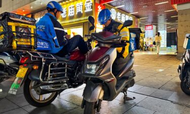 Food delivery worker Yang (left) speaks to CNN about his plight.