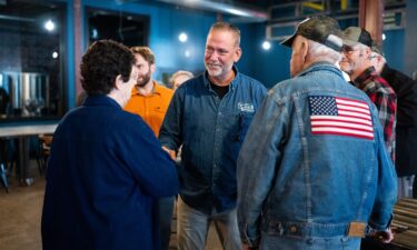 Independent Senate candidate Dan Osborn chats with attendees after speaking during his campaign stop at the Handlebend coffeshop in O'Neill