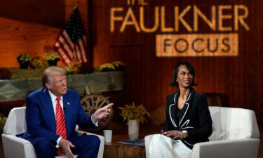 Former President Donald Trump speaks during a break at a Fox News town hall with moderator Harris Faulkner in Cumming