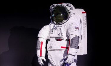 The spacesuit is made from a white material that reflects heat and protects astronauts from extreme high temperatures and lunar dust.