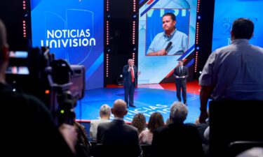 Former President Donald Trump answers a question as moderator Enrique Acevedo looks on during a Univision Noticias town hall event on October 16 in Doral