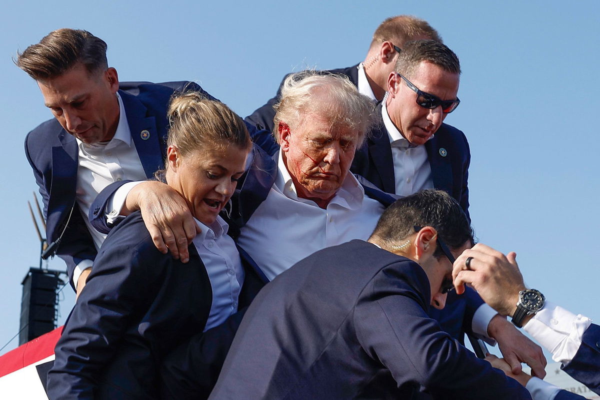 <i>Anna Moneymaker/Getty Images via CNN Newsource</i><br/>Republican presidential candidate former President Donald Trump is rushed offstage by US Secret Service agents after being grazed by a bullet during a rally on July 13