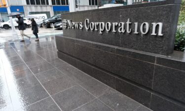 People walk past 1211 Avenue of the Americas the headquarters for News Corp on February 4