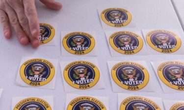 A voter picks up an "I Voted" sticker after casting an early ballot in Arlington