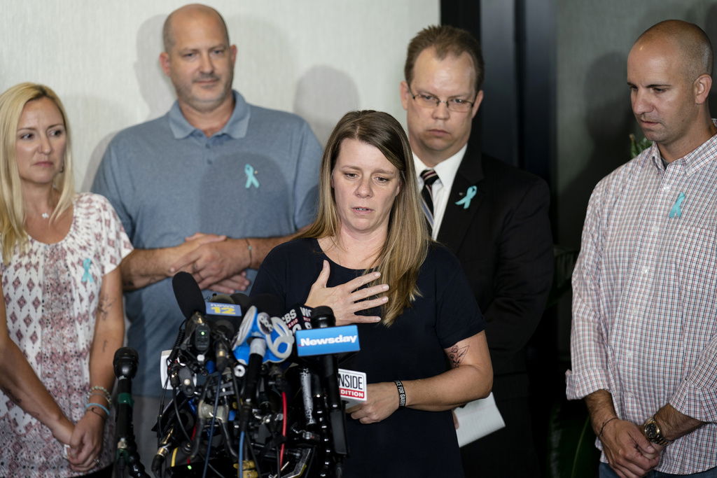 FILE - Nichole Schmidt, mother of Gabby Petito, whose death on a cross-country trip has sparked a manhunt for her boyfriend Brian Laundrie, speaks alongside, from left, Tara Petito, stepmother, Joseph Petito, father, Richard Stafford, family attorney, and Jim Schmidt, stepfather, during a news conference, Sept. 28, 2021, in Bohemia, N.Y. 