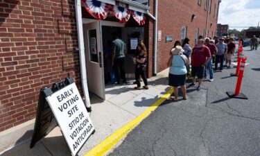 Voters stand in line to cast their ballots on the first day of early voting in Virginia at the Prince William County Office of Elections in Manassas