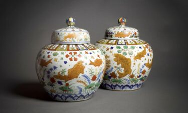 A magnificent and exceptionally rare pair of fish jars and covers.