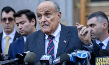 Former New York City Mayor Rudy Giuliani speaks to the members of the media as he leaves court in New York on November 7.