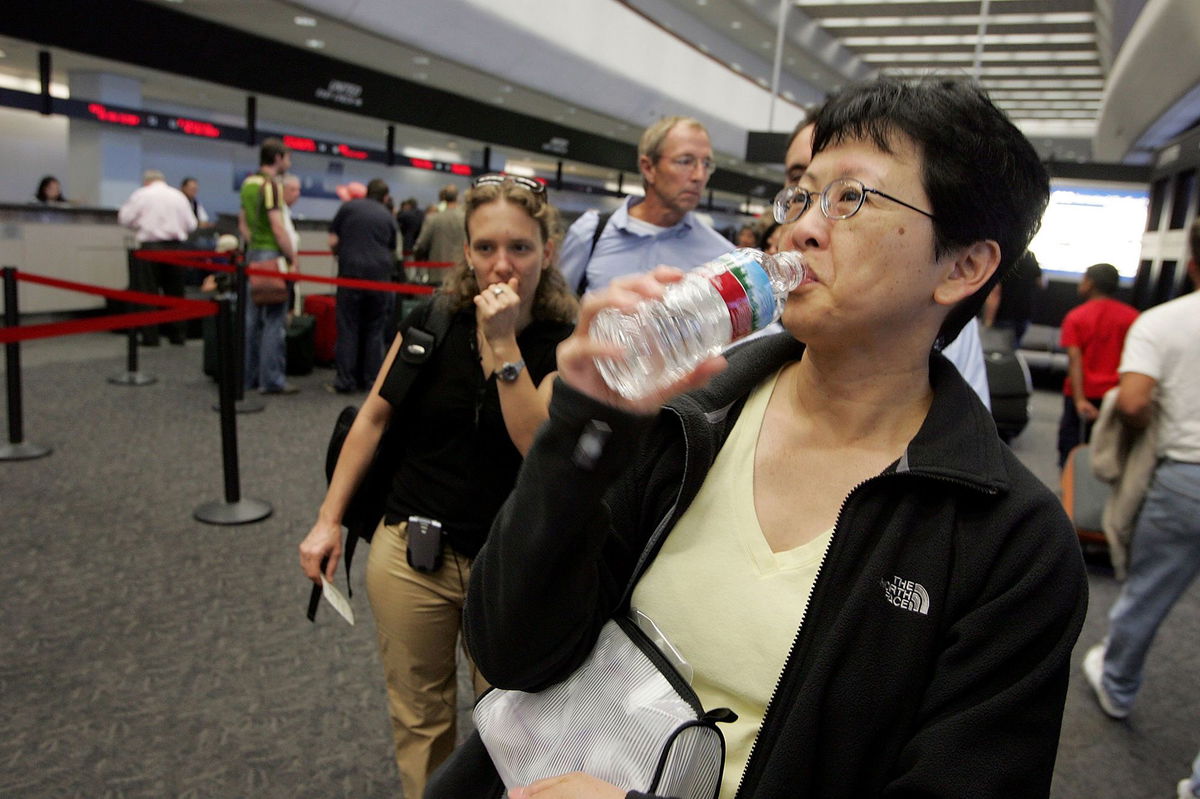 <i>Justin Sullivan/Getty Images via CNN Newsource</i><br/>A passenger takes a sip of water before throwing away the bottle at a security checkpoint at San Francisco International Airport.