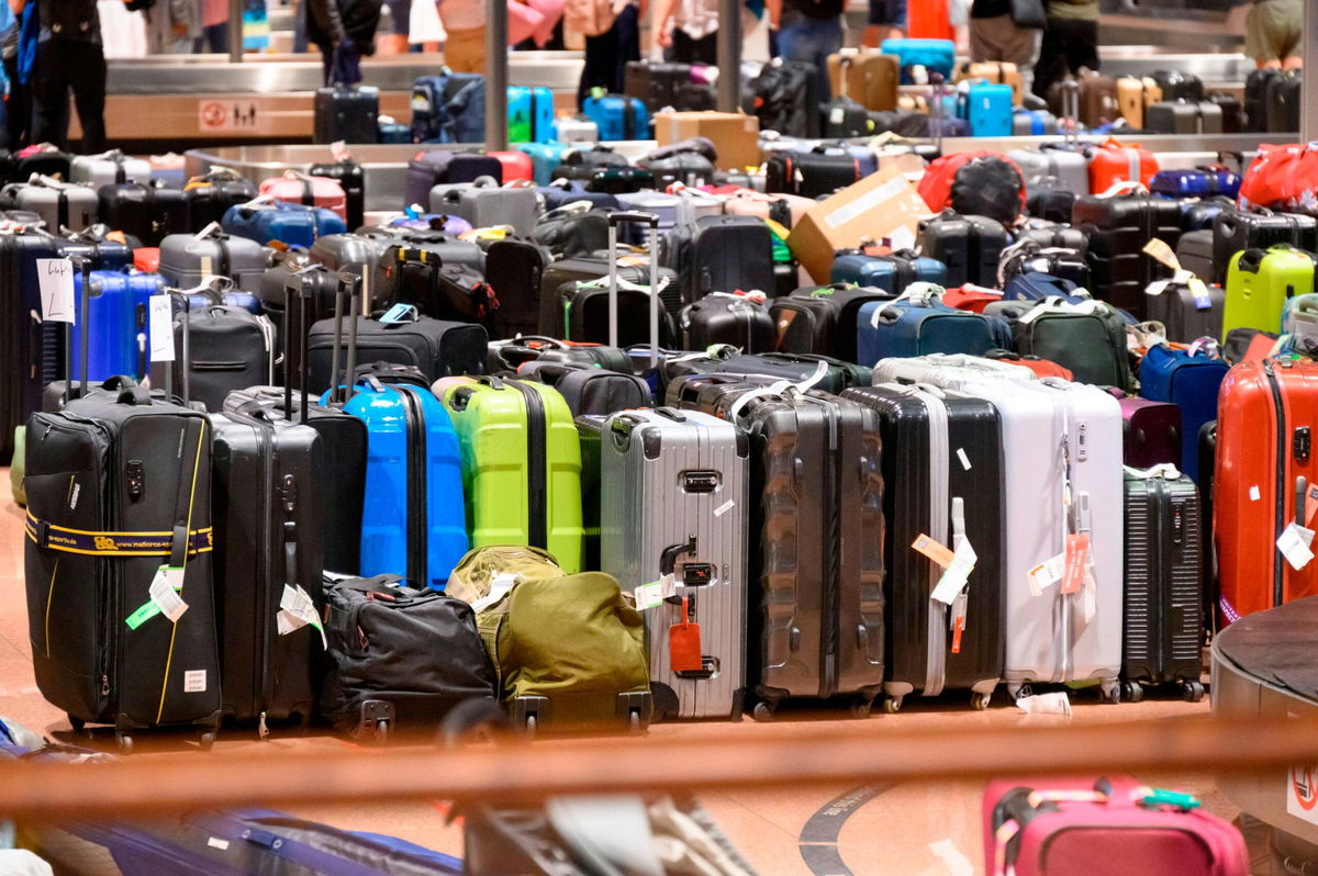 <i>Robert Michael/picture alliance/Getty Images via CNN Newsource</i><br/>Suitcases roll onto a plane at Dresden International Airport in Germany. Your bags have a better chance of arriving at your destination on time if you come to the departing airport on time.