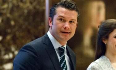 Pete Hegseth walks to an elevator for a meeting with Trump at Trump Tower in New York in 2016.