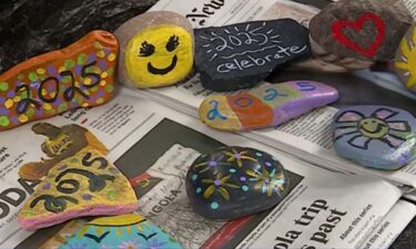 A mother and daughter uses painted rocks to spread inspirational messages for the new year.