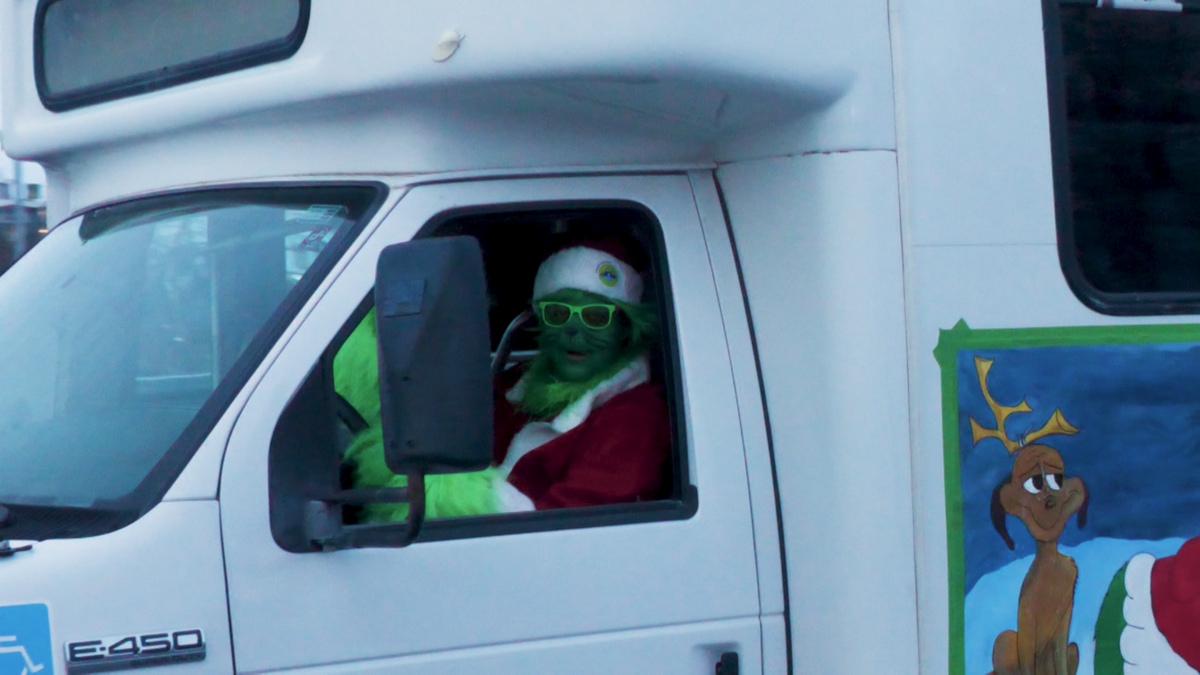 The Grinch helped Santa give out presents to kids this year