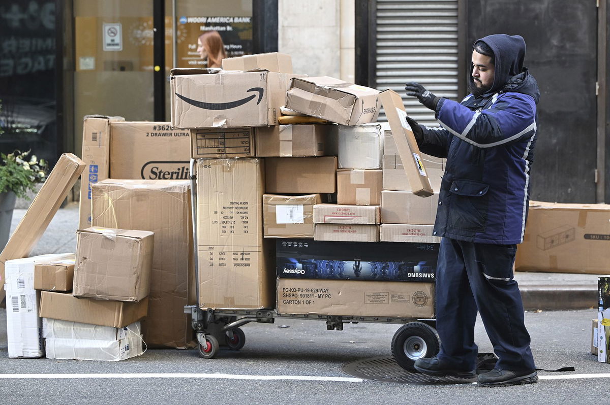 A Fedex worker sorts through packages set for delivery in Manhattan on December 2. Consumers spent a record $13.3 billion on Cyber Monday, according to Adobe Analytics.