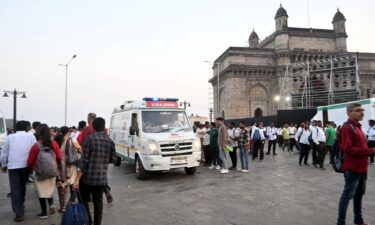 Passengers receive medical attention after a boat capsized off the coast in Mumbai