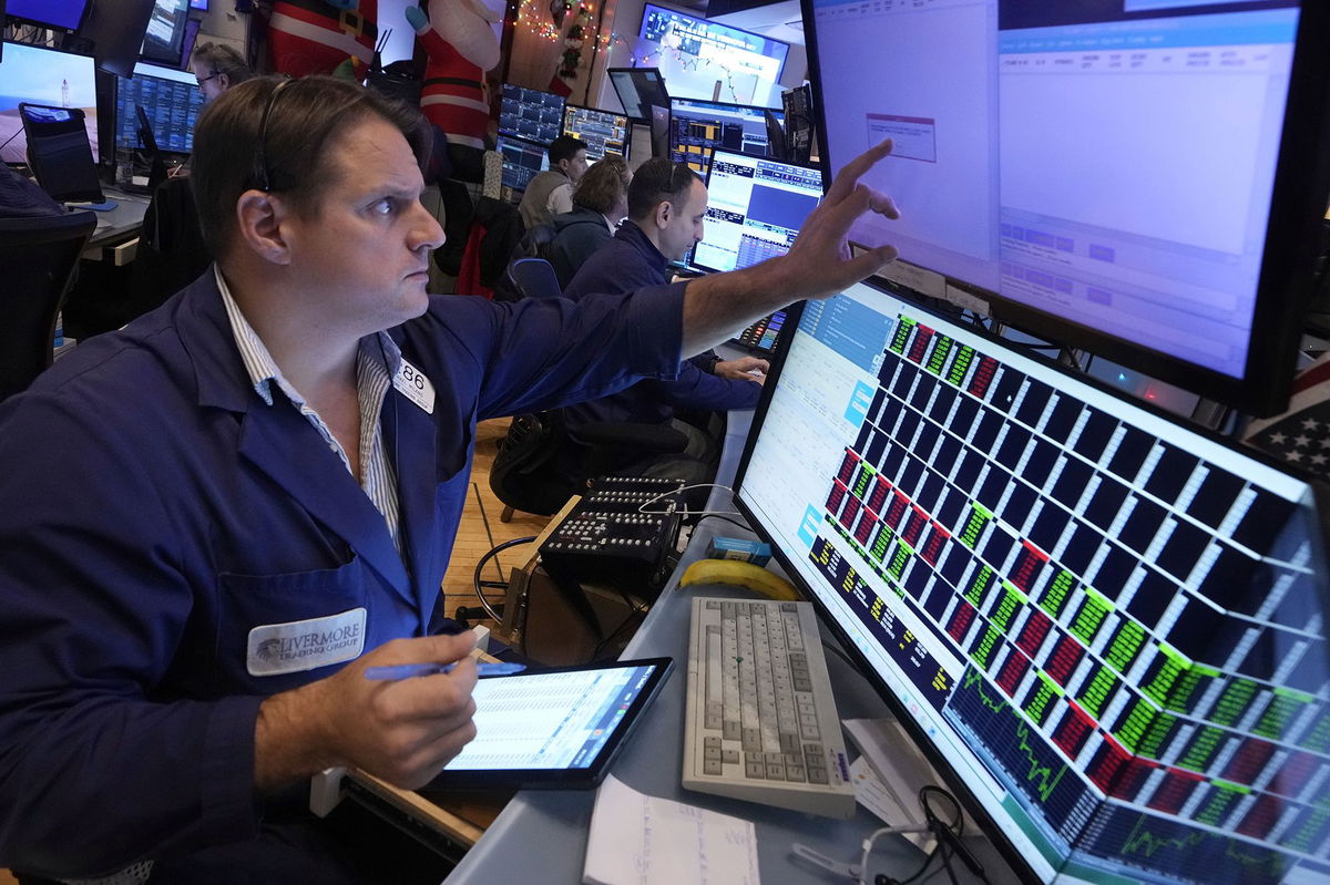 <i>Richard Drew/AP via CNN Newsource</i><br/>Trader Michael Milano works on the floor of the New York Stock Exchange on Dec. 18