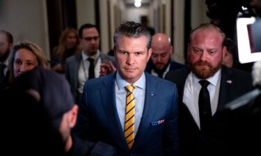 Pete Hegseth walks through the Russell Senate Office Building on Capitol Hill on December 3.