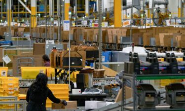 Workers fulfill orders at an Amazon fulfillment center on in Melville