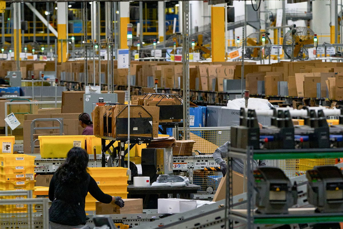 <i>Johnny Milano/Bloomberg/Getty Images via CNN Newsource</i><br/>Workers fulfill orders at an Amazon fulfillment center on in Melville