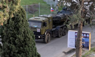 A Russian military vehicle heads towards Hmeimim air base in coastal Latakia