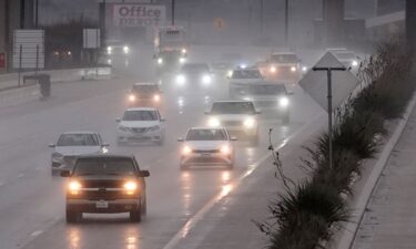 People are seen at a crosswalk on California and Mason street during heavy rain in San Francisco